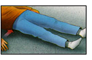A post operative patient lying on a flat surface doing Buttocks Contractions exercizes