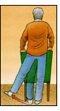 Post operative male patient standing behind and holding onto a chair performing Standing Hip Abduction exercises